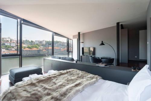 a bedroom with a bed and a large window at MY DOURO VIEW Stylish Gem River Front in Vila Nova de Gaia