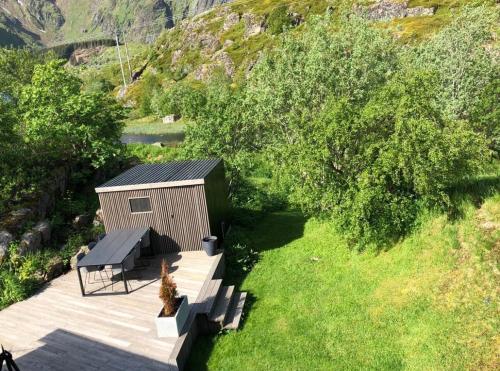 an overhead view of a wooden shed with a picnic table at House in Ballstad in Lofoten in Skotnes