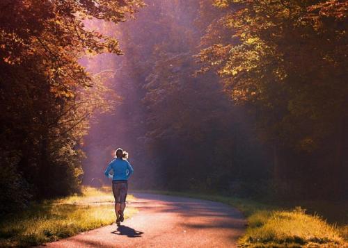 a woman is walking down a road at 4-persoons Tiny Lodge in Voorthuizen