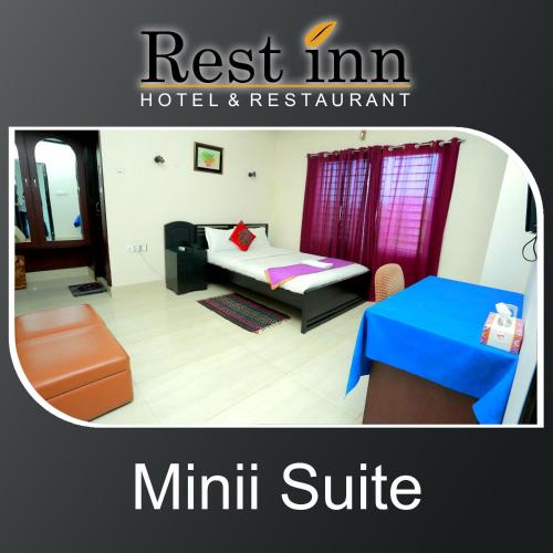 a small room with a bed and a table at Restinn Hotel in Maulvi Bāzār