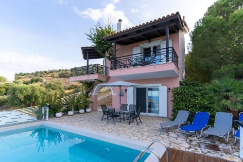 a villa with a swimming pool and a house at Coastal Paradise Found - Komis' Private Pool Retreat in Agios Nikolaos