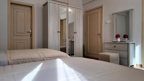 a bedroom with a bed and a dresser and a mirror at Sada Compound (Women Only) سيدات فقط in Riyadh