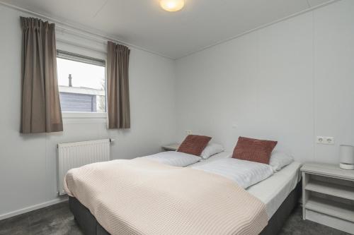 two beds sitting next to each other in a bedroom at Nature Cabin 5 p. in Zuna