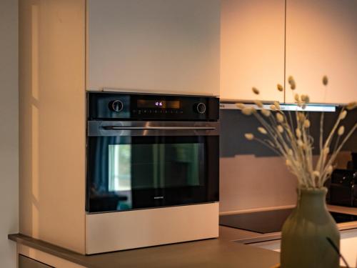 a microwave oven sitting on top of a kitchen counter at Luxe villa met wellness en domotica in Soest