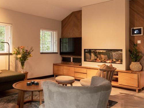 a living room with a fish tank in the wall at Luxe villa met wellness en domotica in Soest
