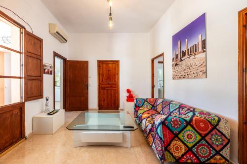 ein Wohnzimmer mit einem Sofa und einem Glastisch in der Unterkunft Can Pep Ramon I in Sant Jordi