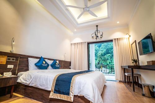 a bedroom with a bed and a large window at Saigon-Ba Be Resort in Ba Be