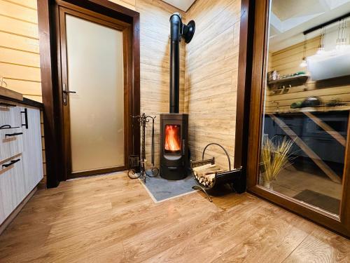 a woodburning stove in a room next to a door at Obriyslavsko in Slavske