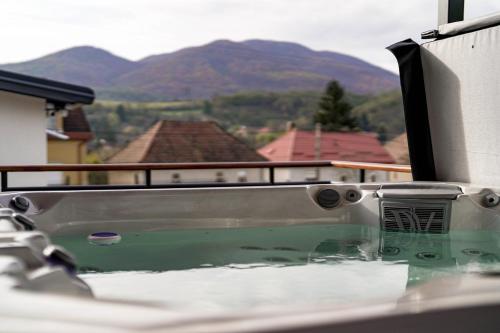 a bath tub with a view of a mountain at Somos Lux Vendégház in Somoskőújfalu