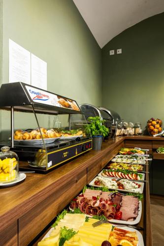 a buffet line with many different types of food at Home Aparthotel in Kraków