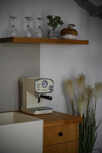a kitchen with a coffee machine on a counter at Aegean Diamonds Luxury Suites in Monolithos
