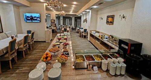 a cafeteria with a long buffet line with food at ApartHotel Olympus Plaza in Kranevo