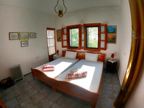 a bedroom with a large bed in a room at Katafigio Home in Tsagkarada Village in Tsagarada