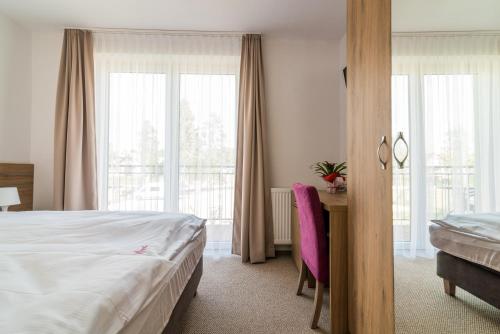 Postel nebo postele na pokoji v ubytování Magnolia pokoje i apartamenty Dębki