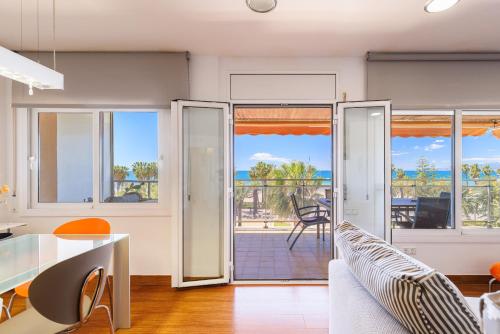 a living room with sliding glass doors to a patio at Tous Planet Costa Dorada Only Families in Salou
