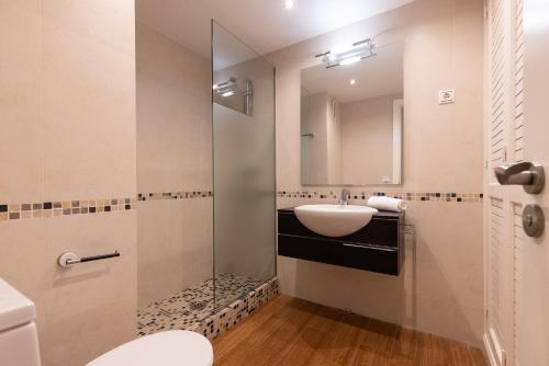 a bathroom with a sink and a mirror at Tous Planet Costa Dorada Only Families in Salou