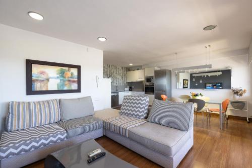 a living room with a couch and a dining room at Tous Planet Costa Dorada Only Families in Salou