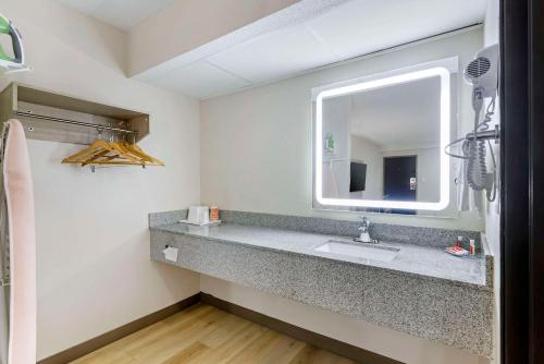 a bathroom with a sink and a mirror at Econo Lodge Augusta, Downtown in Augusta
