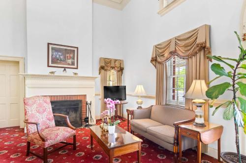 a living room with a couch and a fireplace at Rodeway Inn Williamsburg Edge District in Williamsburg