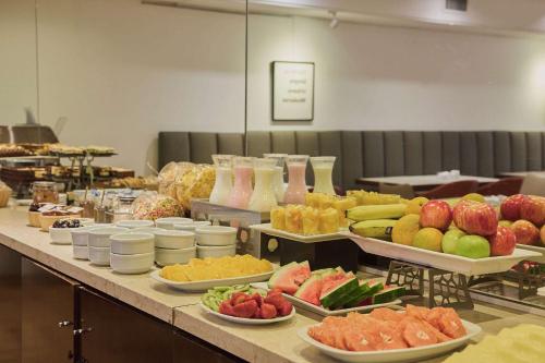 a buffet line with different types of fruits and vegetables at Dazzler by Wyndham Buenos Aires San Martin in Buenos Aires