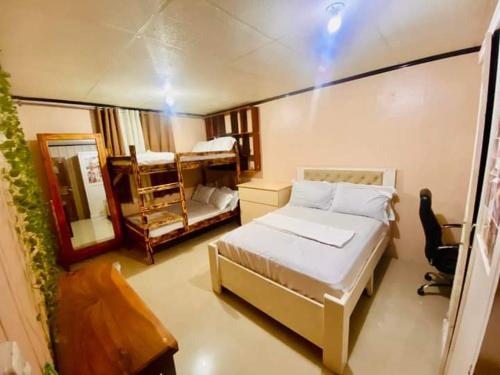 Dormitorio pequeño con cama y espejo en Baguio mountain villa view RW en Baguio