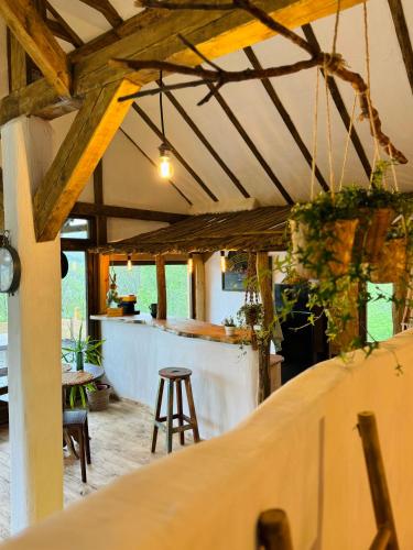a bar with a counter and a stool in a room at Inside, The Village- The Hut Studio in Tunari