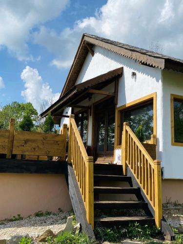 a house with a staircase leading to the front door at Inside, The Village- The Hut Studio in Tunari