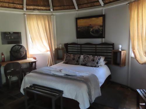 a bedroom with a large bed in a room at Marico Guest Lodge in Groot-Marico