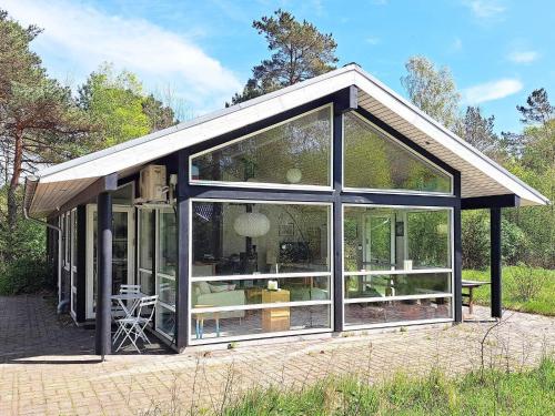 a large glass extension of a house at 8 person holiday home in Hadsund in Hadsund