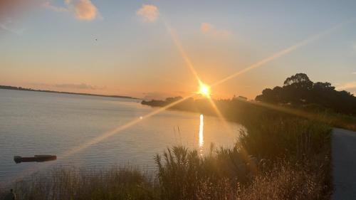 a sunset over a body of water at La Mimosa Case Vacanze in Marsala