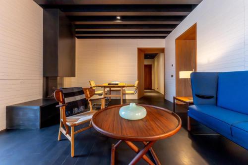 a living room with a blue couch and a table at Atrio in Cáceres