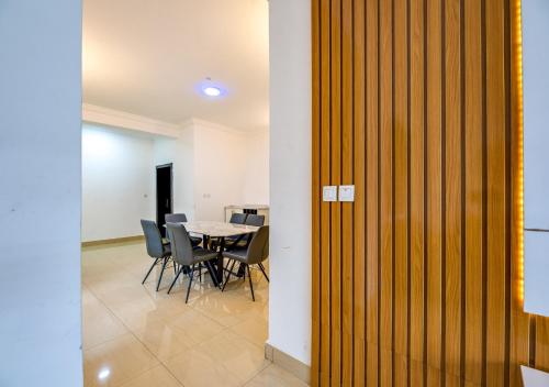 a dining room with a table and chairs at Lakowe Lakes Hotel, Golf and Country Estate by NEWMARK in Lagos