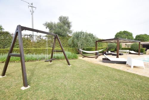 a playground with two swings and a hammock at Mythos Holidays & Events in Siracusa