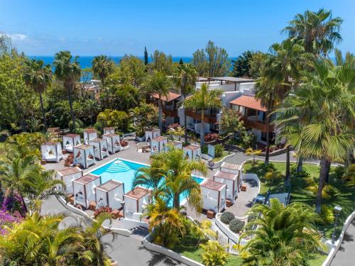 an aerial view of a resort with a pool and palm trees at Hotel Jardín Tecina in Playa de Santiago