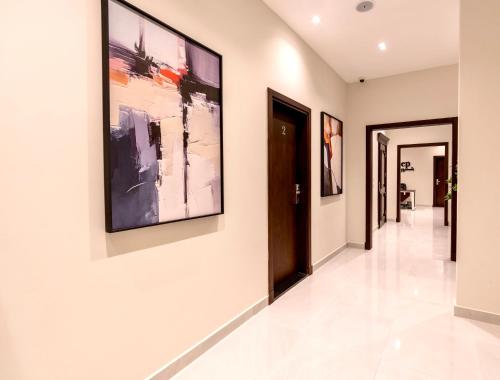 a hallway with paintings on the walls at Sleep Inn Apart-Hotel in Cairo