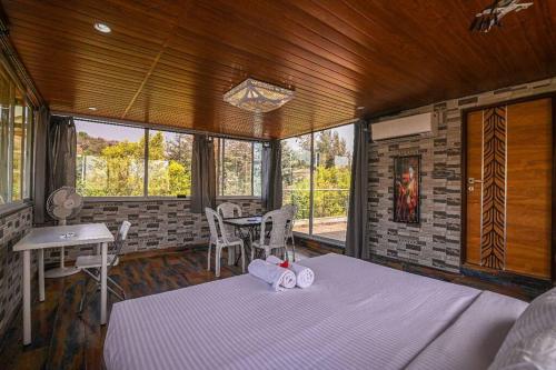 a bedroom with a bed in a room with a fireplace at Misty Palace Luxury Villa by Natura Stays in Lonavala