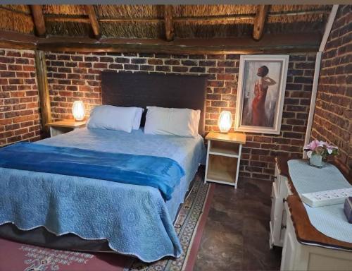a bedroom with two beds in a brick wall at Midvaal Guesthouse in Meyerton
