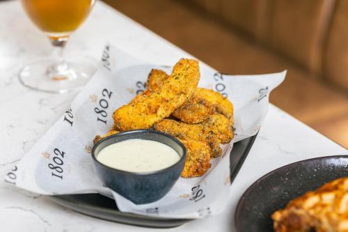 a plate of food with a bowl of dipping sauce at Courtyard by Marriott Edinburgh in Edinburgh