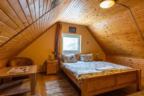 a bedroom with a bed in a attic at Penzion Jas in Zuberec