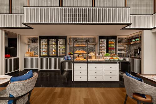 a restaurant with a counter with food on it at Chiang Mai Marriott Hotel in Chiang Mai