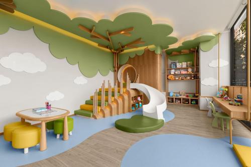 a childrens play area with a tree mural on the wall at Chiang Mai Marriott Hotel in Chiang Mai