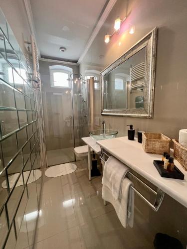 a bathroom with a shower and a sink and a mirror at Sopot Spa Apartament in Sopot