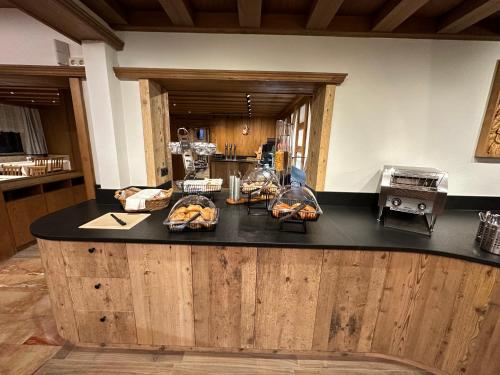 a kitchen with a black counter with food on it at Hotel Alpenblick in Bach
