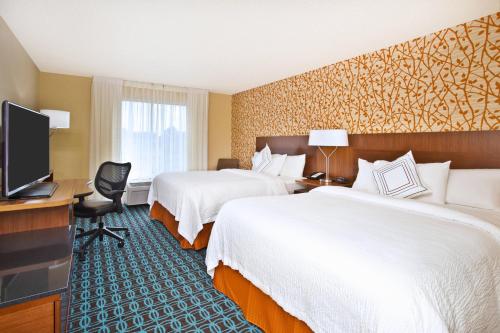 a hotel room with two beds and a television at Fairfield Inn & Suites by Marriott Madison West/Middleton in Madison