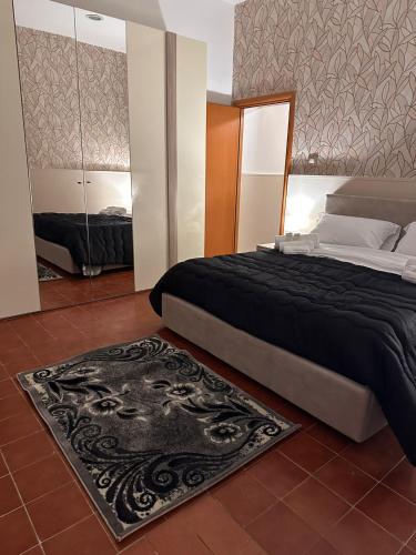a bedroom with a large bed and a rug at La casetta di Ludovica in Siracusa