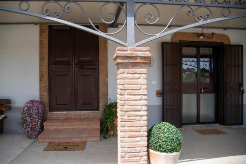 a house with two doors and a brick pillar at Sentiero Degli Ulivi Mascia in Caiazzo