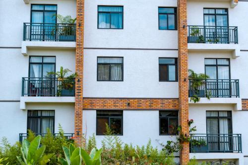 an apartment building with windows and plants at MAYA Residences Rwanda in Kigali