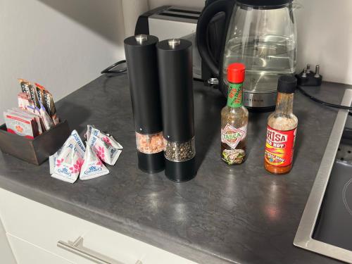 a counter with spices and bottles of alcohol on it at The Legacy BnB in East London