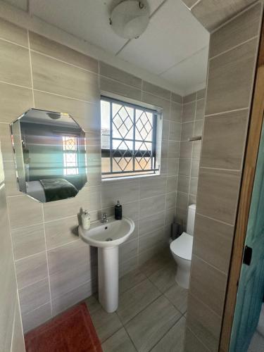 a bathroom with a sink and a toilet at The Legacy BnB in East London