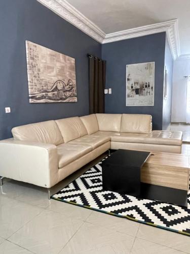 sala de estar con sofá y alfombra en Villa 2 chambres salon, en Abomey-Calavi